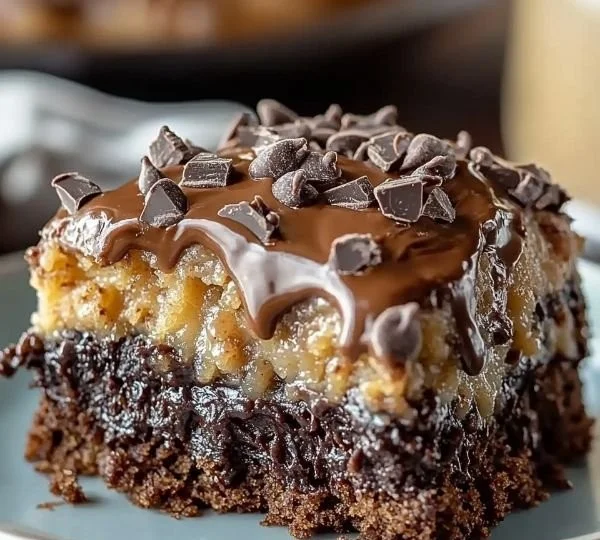 Delicious German Chocolate Poke Cake topped with chocolate and coconut frosting