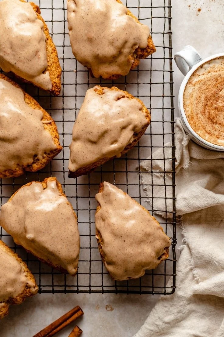 Delicious homemade chai scones topped with maple chai glaze on a rustic table