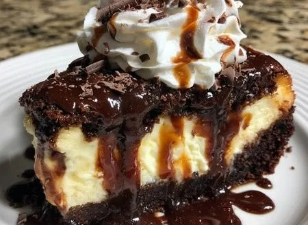 Decadent hot fudge sundae brownie cheesecake topped with chocolate sauce and walnuts.