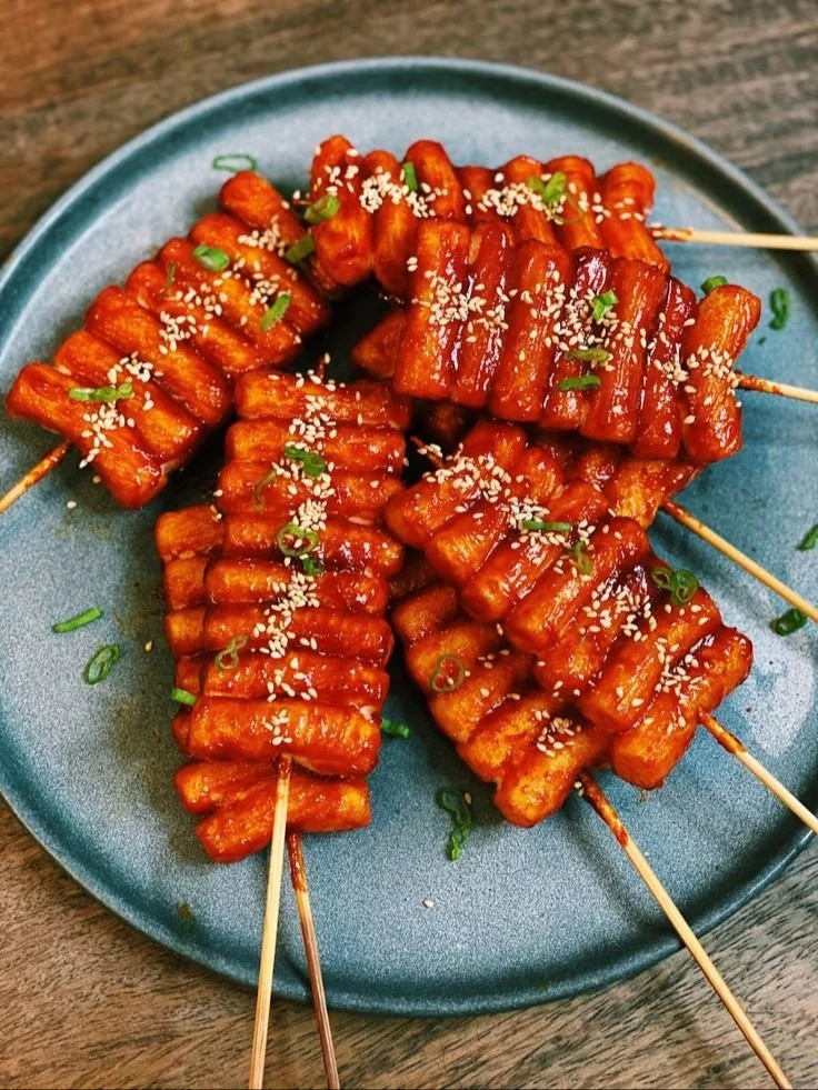 Delicious Tteok Kkochi - Korean spicy rice cake skewers served with sauce.