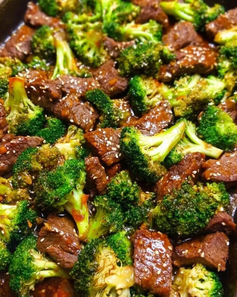 Sheet Pan Beef and Broccoli served with rice on a dinner plate.