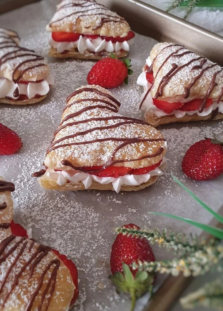 Delicious Strawberry Cream Puffs topped with fresh strawberries and cream