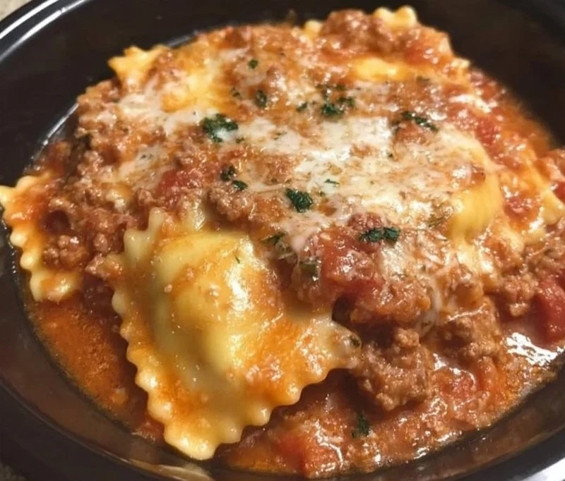 Crockpot Ravioli Lasagna with layers of cheese and sauce in a slow cooker