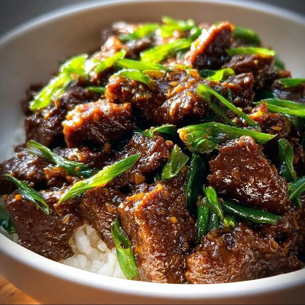 Delicious Slow Cooker Mongolian Beef served with vegetables and rice.