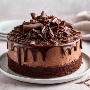 Decadent Chocolate Mint Cake topped with mint leaves and chocolate drizzle